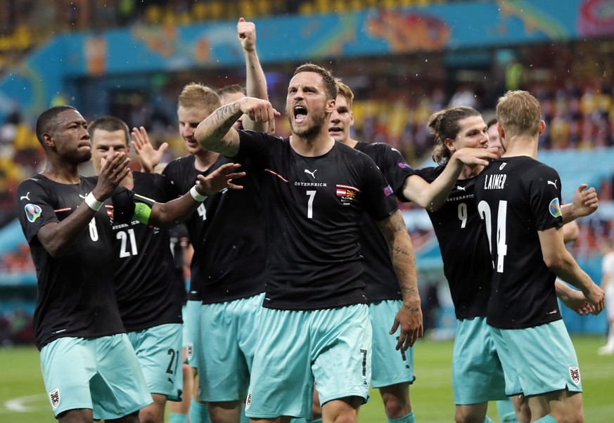 epa09268193 Marko Arnautovic (C) of Austria celebrates with team-mates after scoring the 3-1 goal during the UEFA EURO 2020 group C preliminary round soccer match between Austria and North Macedonia i ...