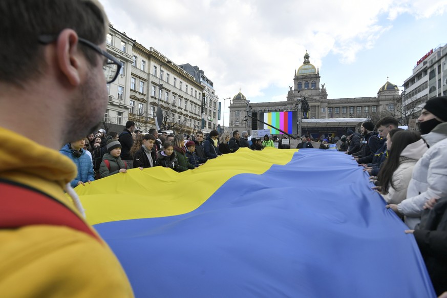 People with an Ukrainian flag protest against Russian invasion to Ukraine at� the Wenceslaw square, in Prague, on Sunday, Feb. 27, 2022. (Michaela Rihova/CTK via AP) ** SLOVAKIA OUT **