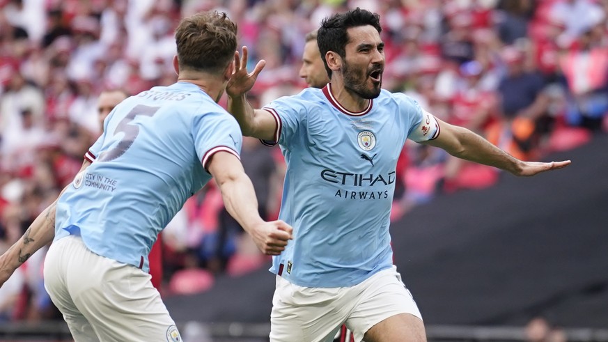 Manchester City&#039;s Ilkay Gundogan, right, celebrates after scoring his side&#039;s second goal during the English FA Cup final soccer match between Manchester City and Manchester United at Wembley ...