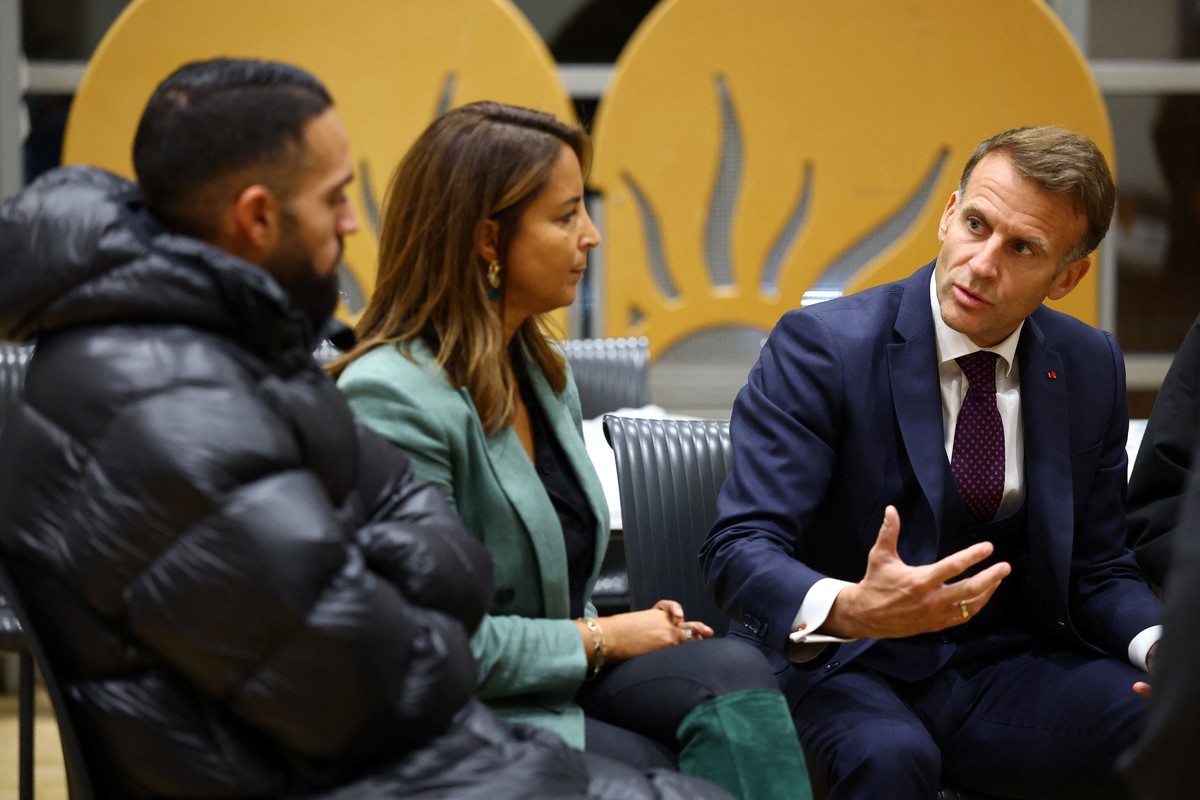 French President Emmanuel Macron speaks with community members at the town hall in Trappes, near Paris, France, Friday Oct. 23, 2026, after a shooting in the Parisian suburb left one person dead and s ...