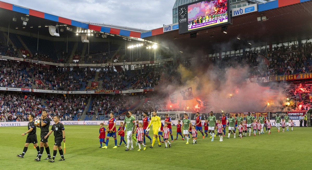 The teams enter the pitch prior to the UEFA Champions League second qualifying round second leg match between Switzerland's FC Basel 1893 and Netherland's PSV Eindhoven in the St. Jakob-Park ...