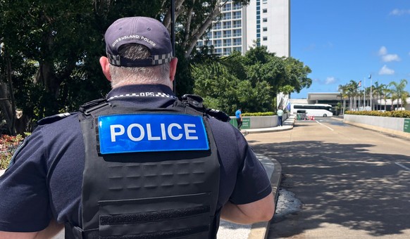 A police officer stands by his car that blocks the entrance to a hotel resort where the Iranian women's soccer team is staying on the Gold Coast, Australia, Tuesday, March 10, 2026. (AP Photo/Joh ...