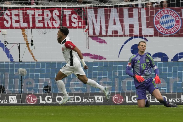 Frankfurt&#039;s Omar Marmoush, centre, celebrates after scoring his side&#039;s first goal past Bayern&#039;s goalkeeper Manuel Neuer during the German Bundesliga soccer match between Eintracht Frank ...