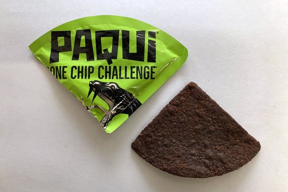 FILE - A Paqui One Chip Challenge chip is displayed in Boston, Friday, Sept. 8, 2023. A medical examiner says a Massachusetts teen who participated in a spicy tortilla chip challenge died from ingesti ...