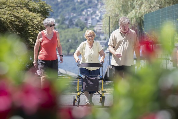 Summer vacation guest at Lido Mappo campground Sophie Marty, a centenarian from Lucerne, is pictured with her daughter Yvonne and Tommaso Pedrazzini, campground director, in Tenero, Switzerland, Thurs ...