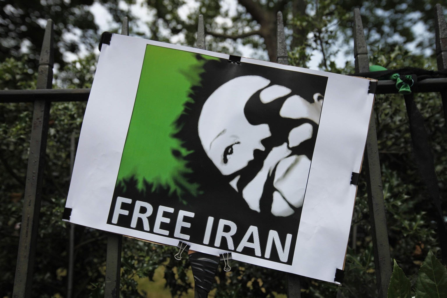 A placard with a picture identified by protesters as Neda Agha Soltan, the woman shown on camera phone footage falling, apparently shot, during a mass protest following Iran's elections, is seen  ...