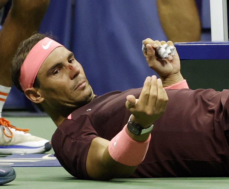 epa10153891 Rafael Nadal of Spain looks up after he hit himself in the face with his racquet during his match against Fabio Fognini of Italy during their second round match of the US Open Tennis Champ ...