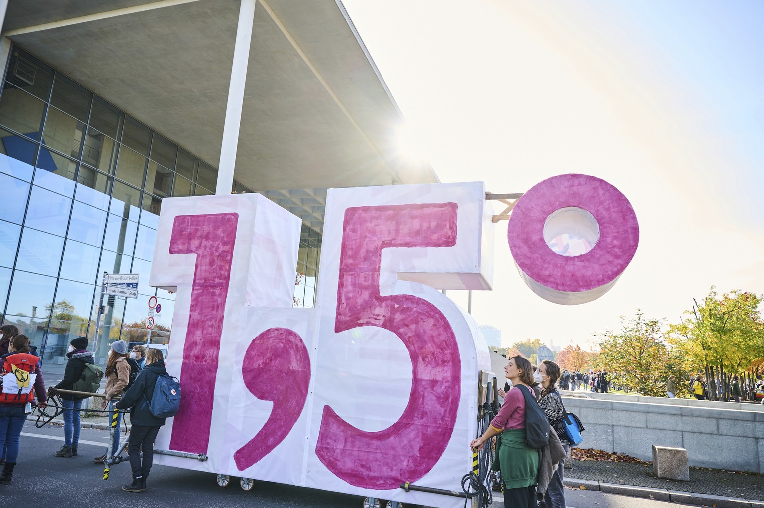 This Oct. 24, 2021 taken photo shows demonstrators from Extinction Rebellion push a self-made cart in the shape of the climate target &quot;1.5&quot; in Berlin, Germany. Officials say a target for ric ...