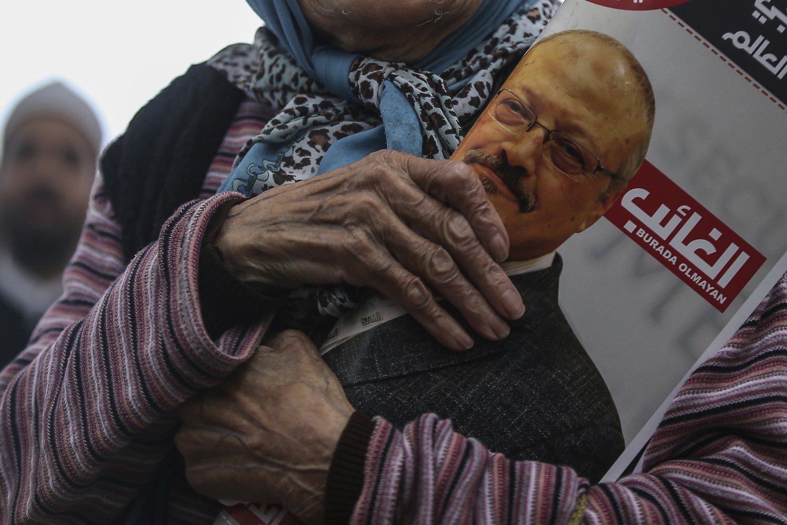 A woman holds a poster during the funeral prayers in absentia for Saudi writer Jamal Khashoggi who was killed last month in the Saudi Arabia consulate, in Istanbul, Friday, Nov. 16, 2018. Turkey&#039; ...