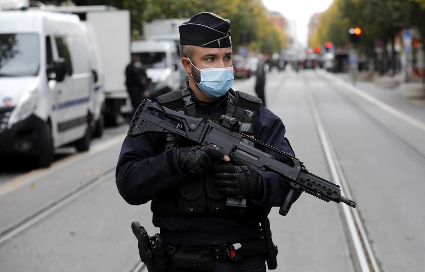 epa08782878 Armed French police officers secure the street near the entrance of the Notre Dame Basilica church in Nice, France, 29 October 2020, following a knife attack. According to recent reports,  ...