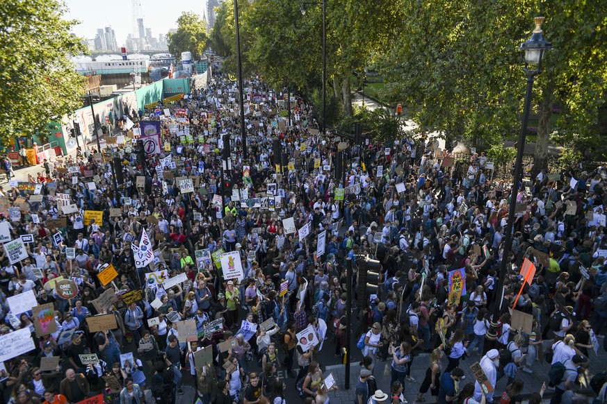 Climate protesters demonstrate in London, Friday, Sept. 20, 2019. In Canberra and Kabul, Cape Town and Berlin, and across the globe, hundreds of thousands of people took the streets Friday to demand t ...