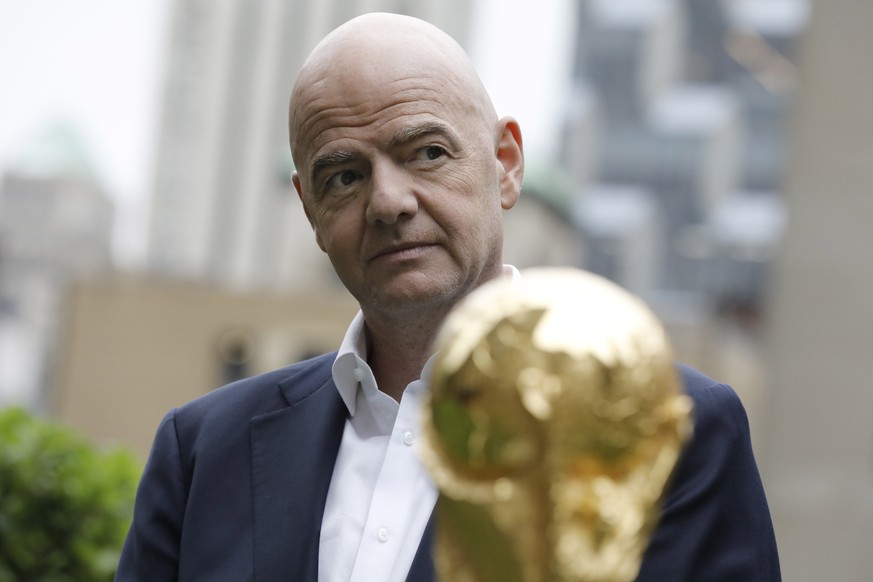 epa10017328 FIFA President Gianni Infantino, poses for photographers with the FIFA World Cup trophy at Radio City in New York, New York, USA, 16 June 2022.The North American cities hosting the 2026 Wo ...