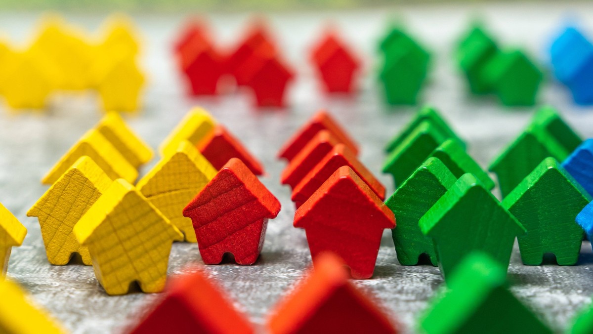 Bavaria, Germany - July 8, 2026: PHOTOMONTAGE. Colorful wooden houses symbolize the housing market and represent housing, real estate, and the development of living spaces. The image illustrates theme ...
