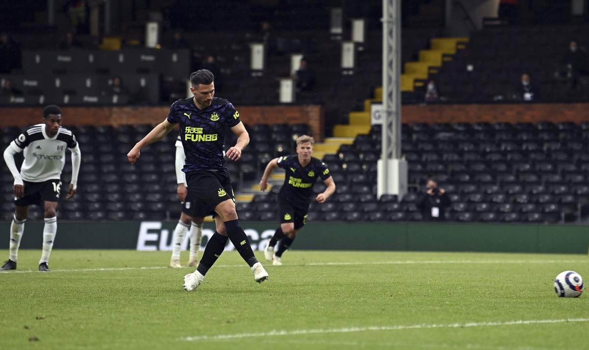 Newcastle United's Fabian Schar scores the second goal of the game during their English Premier League soccer match against Fulham at Craven Cottage, London, Sunday, May 23, 2021. (Glyn Kirk/Pool ...