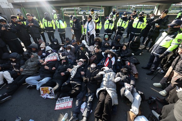 epa11801898 People supporting impeached President Yoon Suk Yeol lie down in front of his official residence in Seoul, South Korea, 02 January 2025, as the state anti-corruption agency is likely to pro ...