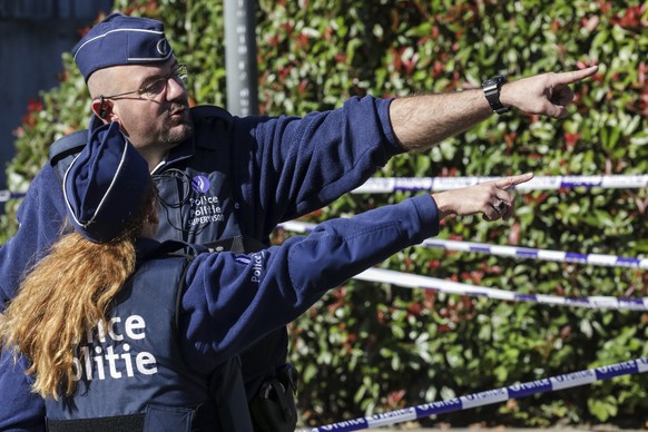 Police investigate the scene where a man stabbed two police officers, in the Schaerbeek neighborhood in Brussels, Wednesday, Oct. 5, 2016. The man stabbed one officer in the neck and the other in the  ...