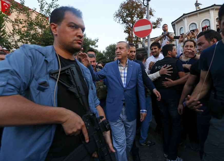 Turkish President Tayyip Erdogan walks through the crowd of supporters protected by bodyguards in Istanbul, Turkey, July 16, 2016. REUTERS/Murad Sezer TPX IMAGES OF THE DAY