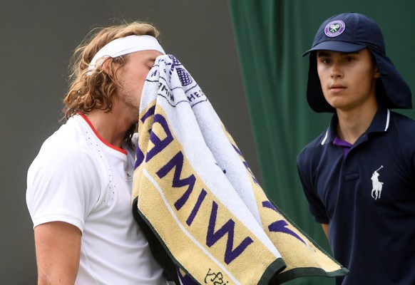 epa07687547 Stefanos Tsitsipas of Greece in action against Thomas Fabbiano of Italy during their first round match at the Wimbledon Championships at the All England Lawn Tennis Club, in London, Britai ...