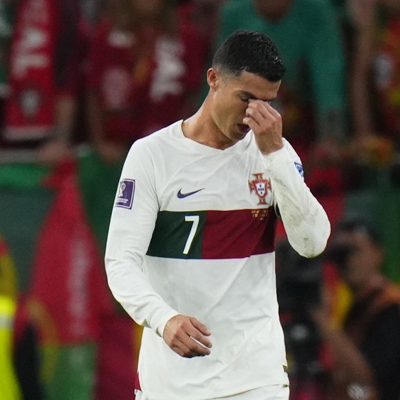 Portugal&#039;s Cristiano Ronaldo, centre, reacts end of the World Cup quarterfinal soccer match between Morocco and Portugal, at Al Thumama Stadium in Doha, Qatar, Saturday, Dec. 10, 2022. (AP Photo/ ...