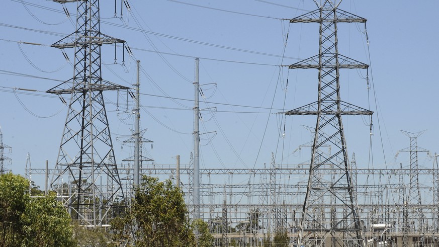 FILE - In this Nov. 3, 2009, file photo, powerlines run across a section near Brisbane. Households will pay significantly more for their power when a proposed Emissions Trading Scheme is introduced. T ...