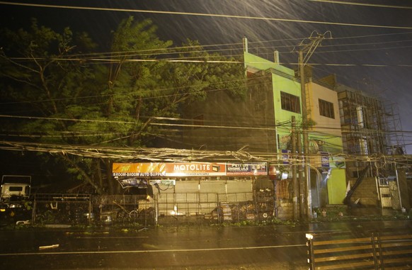 Strong winds and rain batter a town as Typhoon Mangkhut hits Tuguegarao city, Cagayan province, northeastern Philippines on Saturday, Sept. 15, 2018. Typhoon Mangkhut slammed into the country&#039;s n ...