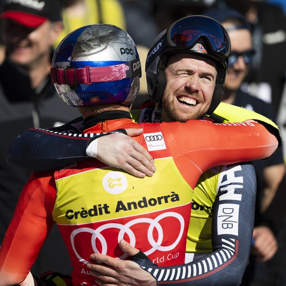 Aleksander Aamodt Kilde of Norway, right, hugs Marco Odermatt of Switzerland in the finish area during the men&#039;s super-g race at the FIS Alpine Skiing World Cup finals in El Tarter, Andorra, Thur ...
