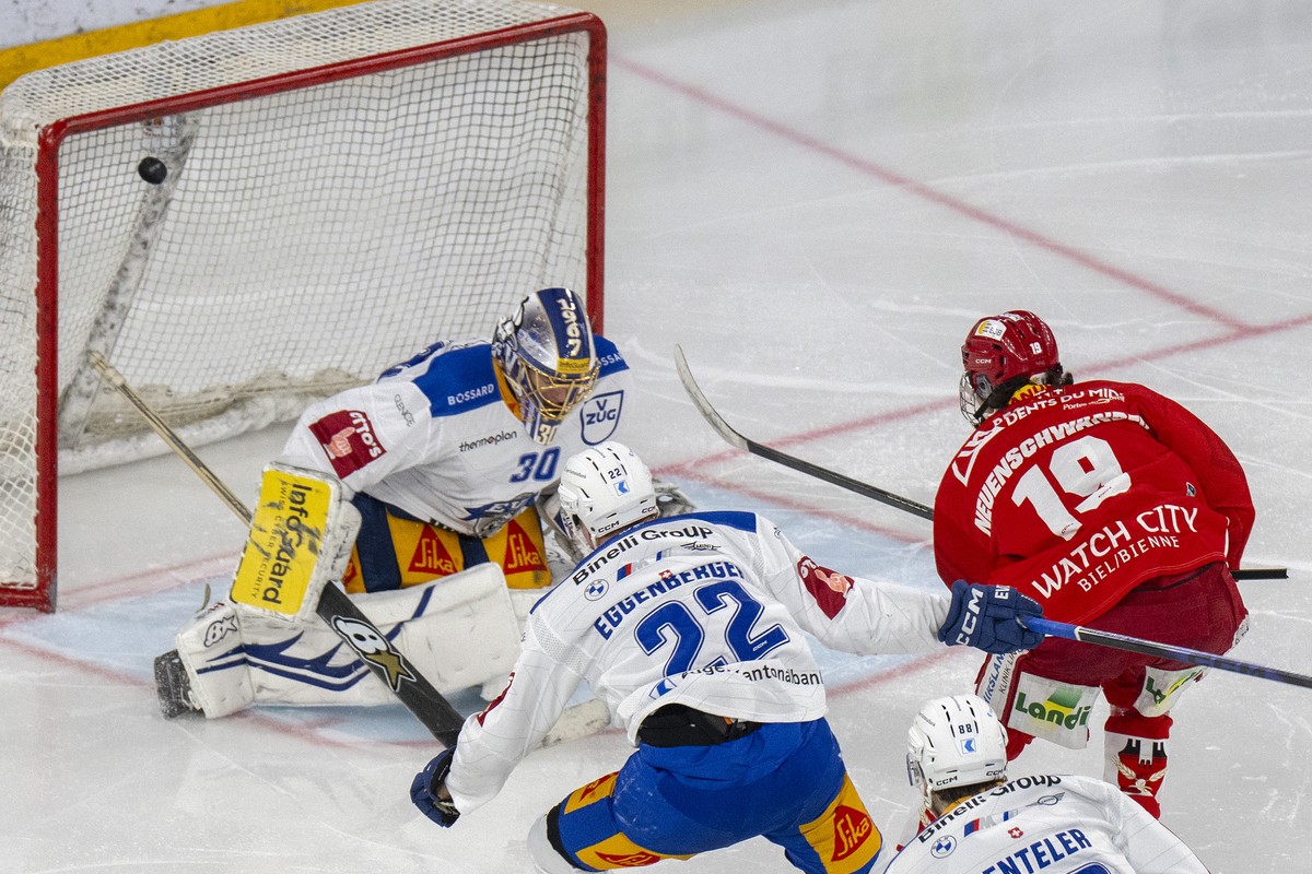 Jonah Neuenschwander (EHCB), rechts, trifft gegen Torhueter Leonardo Genoni (EVZ) zum 2-1 im Spiel der Eishockey National League zwischen EHC Biel-Bienne, EHCB, und EV Zug, EVZ, vom $Friday$, 27. $Feb ...
