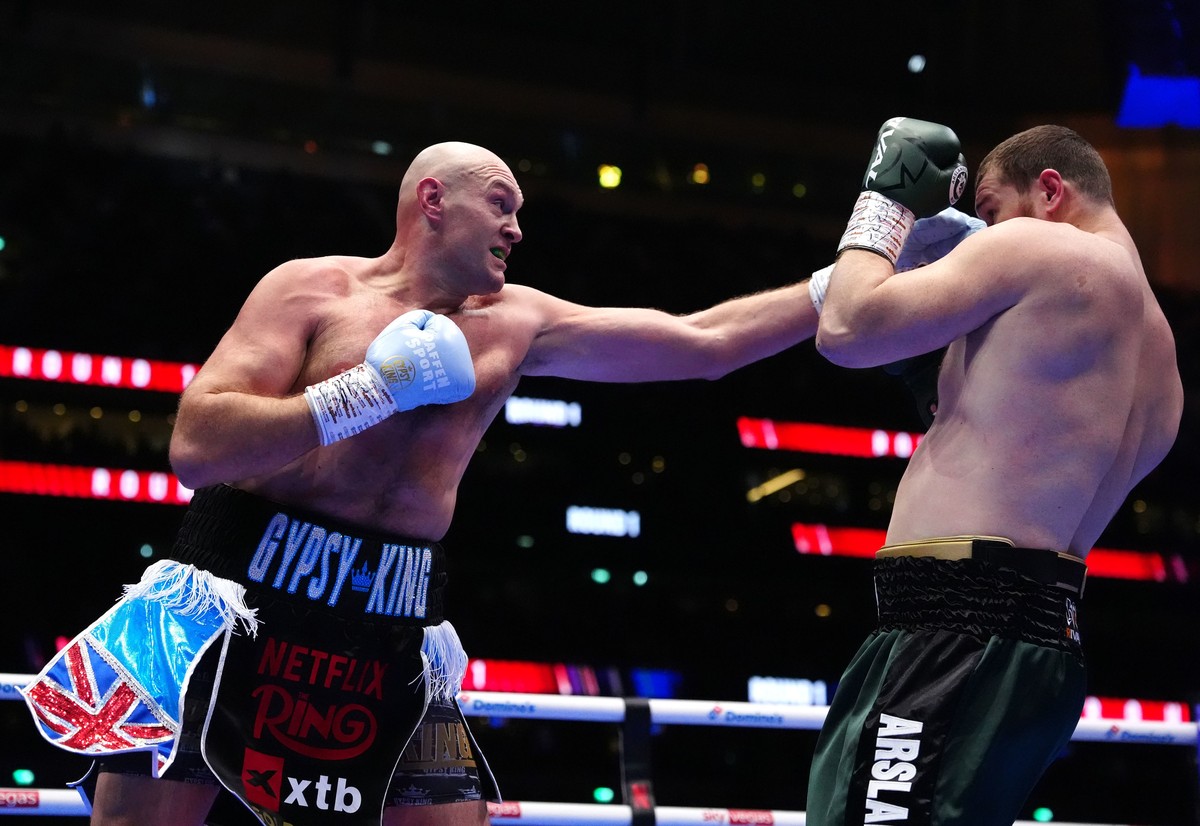 Boxer Tyson Fury, left, punches Arslanbek Makhmudov during a heavyweight bout at Tottenham Hotspur Stadium in London, Saturday, April 11, 2026. (Bradley Collyer/PA via AP)
Britain Fury Makhmudov Boxin ...