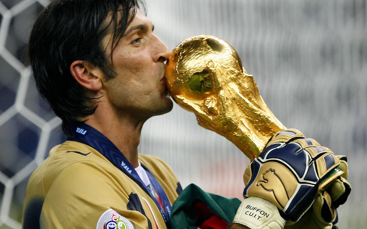 Italy's goal keeper Gianluigi Buffon kisses the World Cup trophy after the final of the soccer World Cup between Italy and France in the Olympic Stadium in Berlin, Sunday, July 9, 2006. Italy bea ...