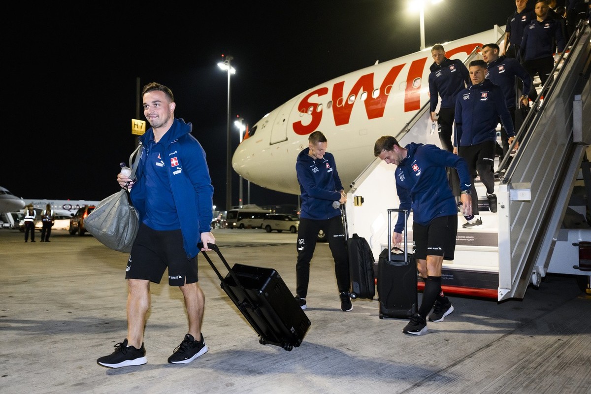 Members of the Switzerland's national soccer team with Switzerland's midfielder Xherdan Shaqiri get off the plane at Hamad International airport in Doha, Qatar, Monday, November 14, 2022. Th ...