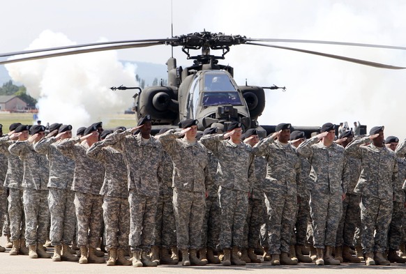 FILE - In this Friday, May 13, 2011 file photo, Soldiers of 1AD attend a color casing ceremony of the First Armored Division at the US Army Airfield in Wiesbaden, Germany. After more than a year of th ...