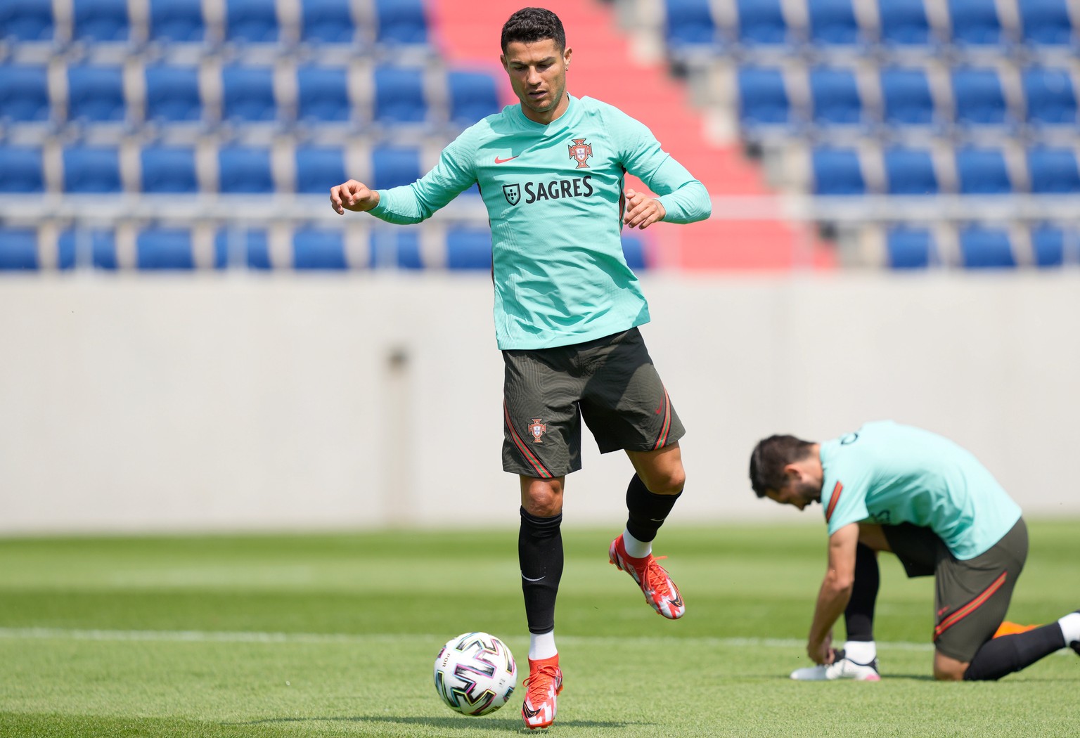 epa09263981 Portugal&#039;s national soccer team players Cristiano Ronaldo (L) and Joao Moutinho (R) in action during a training session at the Illovszky Rudolf Stadium, Budapest, Hungary, 12 June 202 ...