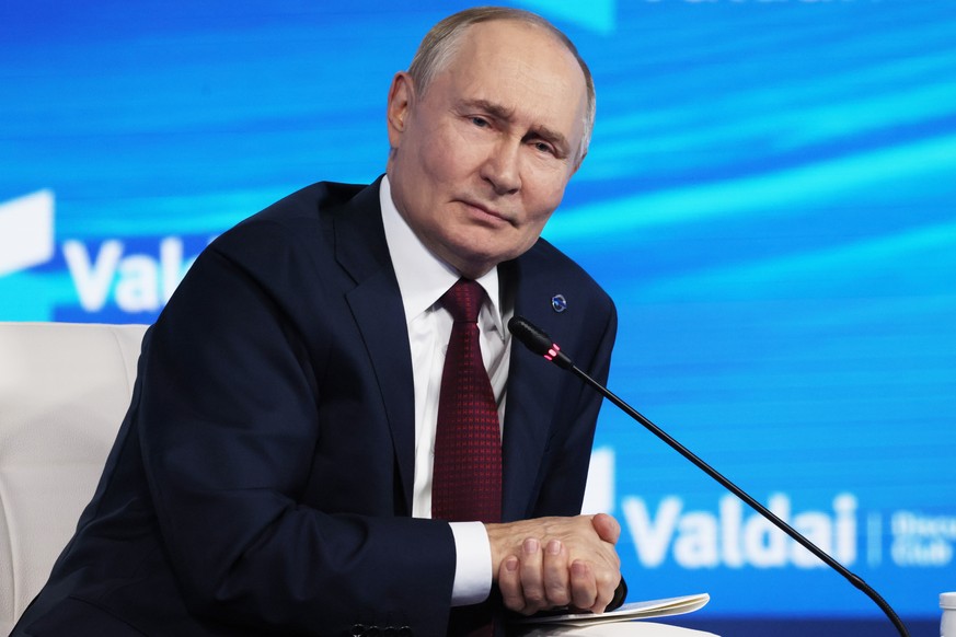 Russian President Vladimir Putin answers questions during a meeting with foreign policy experts at the Valdai Discussion Club in the Black Sea resort of Sochi, Russia, on Thursday, Oct. 2, 2025. (Mikh ...