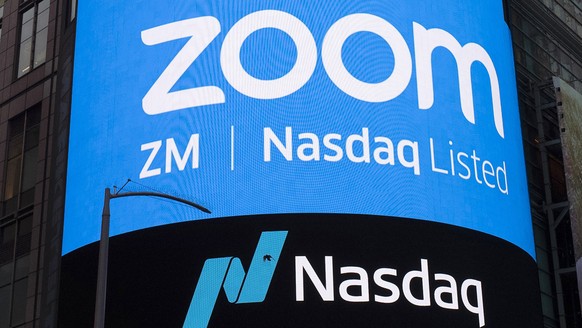FILE - This April 18, 2019, file photo shows a sign for Zoom Video Communications ahead of their Nasdaq IPO in New York. A U.S. government committee that reviews foreign investment in telecom is probi ...