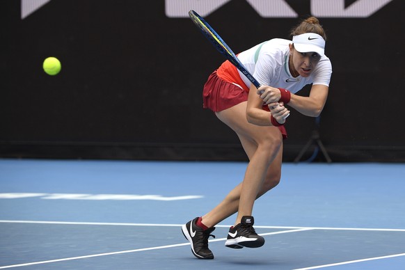 Belinda Bencic of Switzerland plays a backhand return to Kristina Mladenovic of France during their first round match at the Australian Open tennis championships in Melbourne, Australia, Monday, Jan.  ...