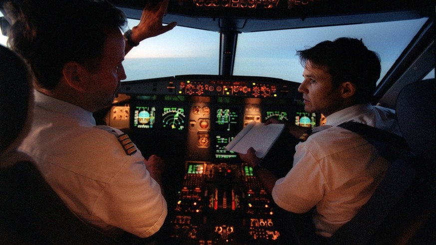 Zwei Piloten sitzen im Cockpit eines Airbus A320 der Edelweiss Air waehrend eines Fluges nach Mallorca, aufgenommen am 22. Maerz 2002. (KEYSTONE/Martin Ruetschi) : FILM]