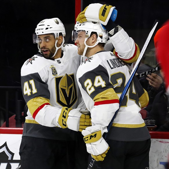 Golden Knights&#039; Pierre-Edouard Bellemare (41) celebrates his goal against the Carolina Hurricanes with teammate Oscar Lindberg (24) during the first period of an NHL hockey game, Sunday, Jan. 21, ...