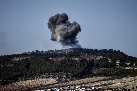 A plume of smoke rises from inside Syria, during Turkish forces bombardment, part of an offensive codenamed Operation Olive Branch, in the Kurdish-controlled enclave of Afrin, Syria, as seen from the  ...