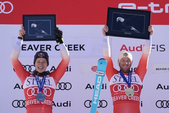 Second place finisher Switzerland&#039;s Marco Odermatt, let, and first place finisher Switzerland&#039;s Justin Murisier celebrate after a men&#039;s World Cup downhill skiing race, Friday, Dec. 6, 2 ...