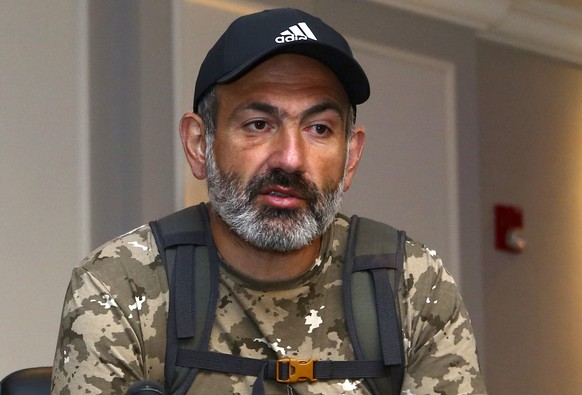 Armenian protest leader Nikola Pashinian speaks to the media in Yerevan, Armenia, Sunday, April 22, 2018, after his short meeting with former Armenian President Serzh Sargsyan, who was named a Prime M ...