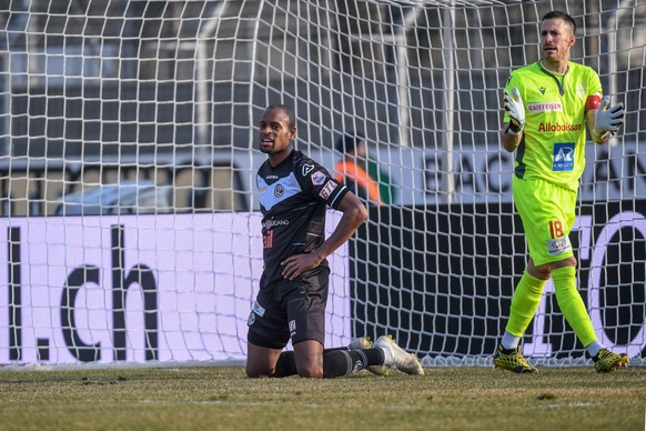 Lugano&#039;s player Rangelo Janga, left, reacts next to Sion&#039;s goalkeeper Kevin Fickentscher, during the Super League soccer match between FC Lugano and FC Sion, at the Cornaredo Stadium in Luga ...