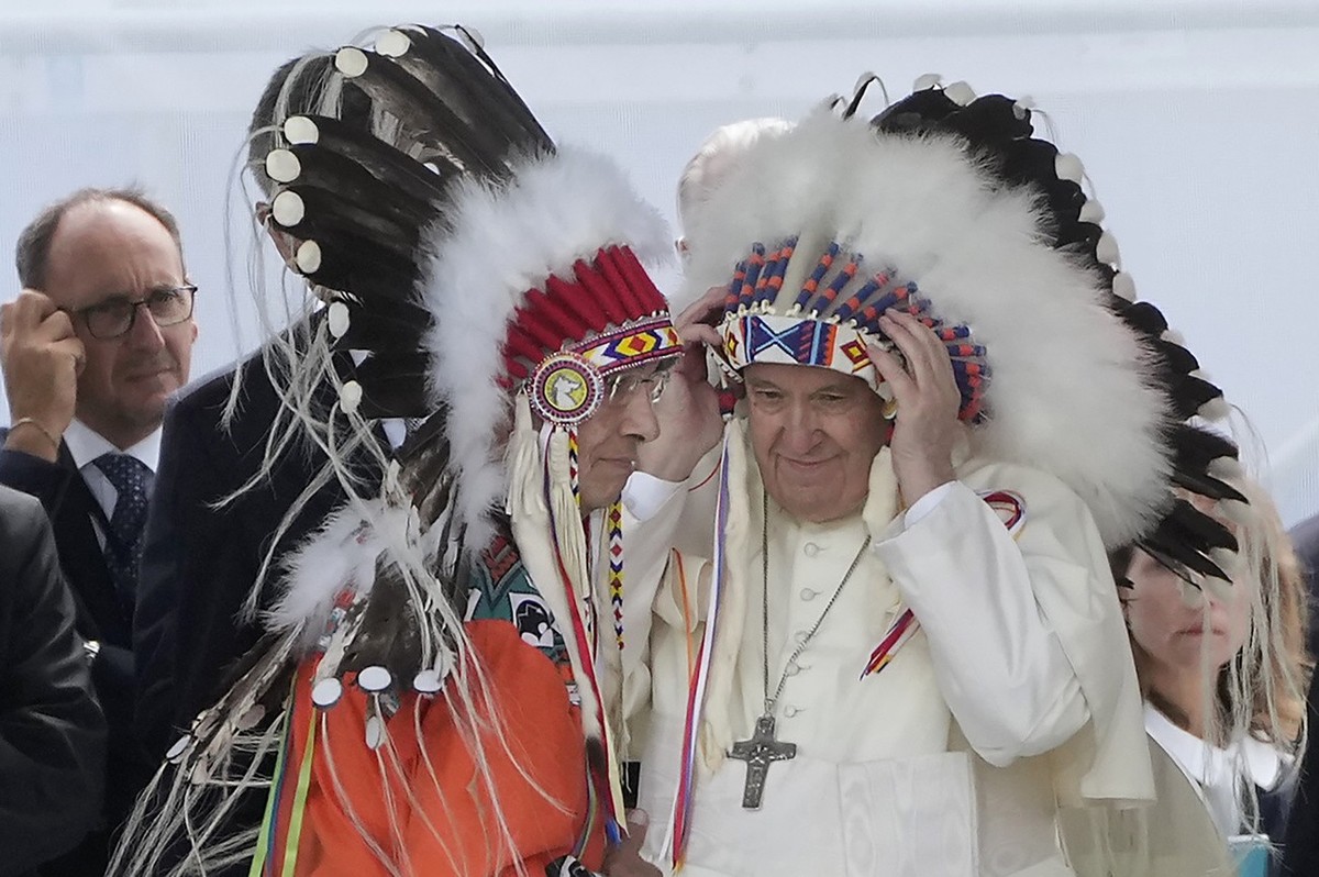 Pope Francis puts on an indigenous headdress during a meeting with indigenous communities, including First Nations, Metis and Inuit, at Our Lady of Seven Sorrows Catholic Church in Maskwacis, near Edm ...
