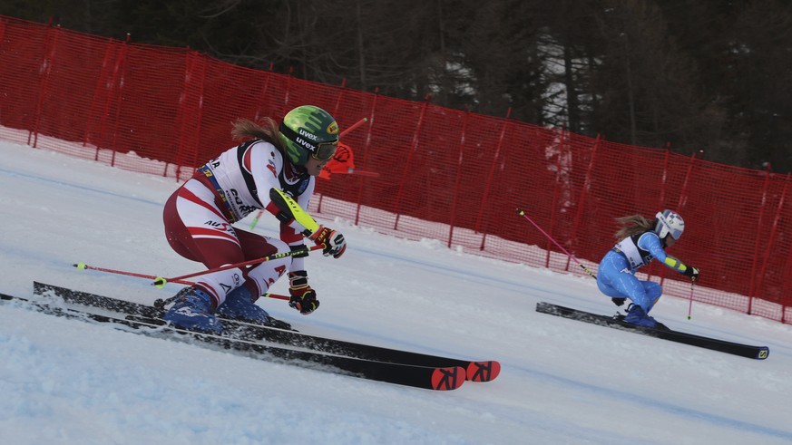 Austria&#039;s Katharina Liensberger and Italy&#039;s Marta Bassino speed down the course on their way to win a gold medal during a parallel slalom, at the alpine ski World Championships, in Cortina d ...