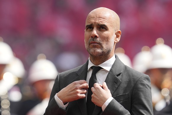 Manchester City&#039;s head coach Pep Guardiola gestures prior to the English FA Cup final soccer match between Manchester City and Manchester United at Wembley Stadium in London, Saturday, May 25, 20 ...