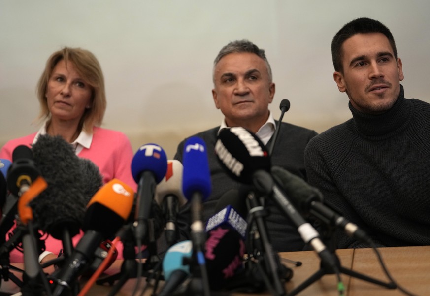 Serbia&#039;s Novak Djokovic&#039;s father Srdjan, center, brother Djordje, right, and mother Dijana attend a press conference in Belgrade, Serbia, Monday, Jan. 10, 2022. Tennis star Novak Djokovic on ...