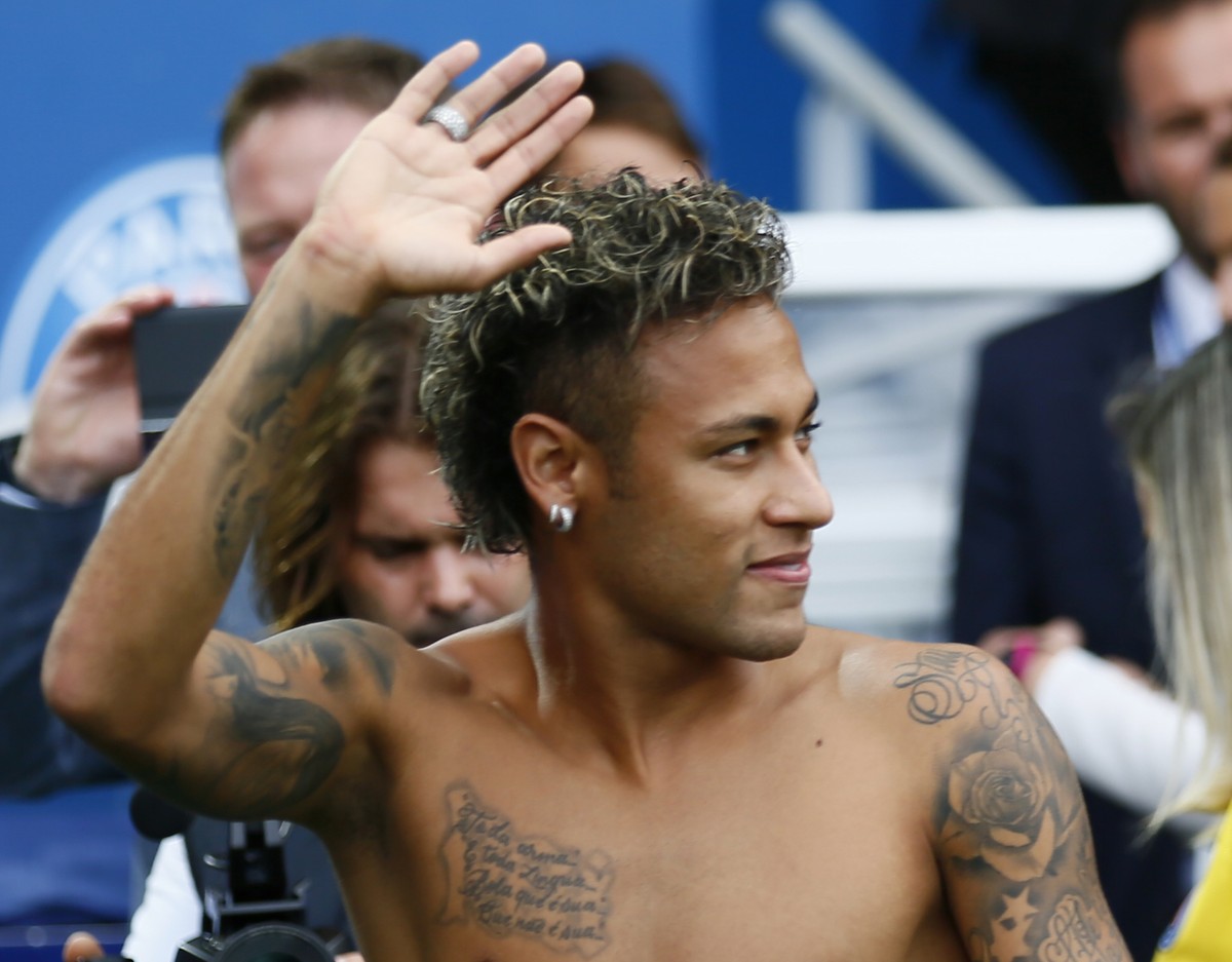 Brazilian soccer star Neymar waves to fans at the Parc des Princes stadium in Paris, Saturday, Aug. 5, 2017, during his official presentation to fans ahead of Paris Saint-Germain's season opening ...