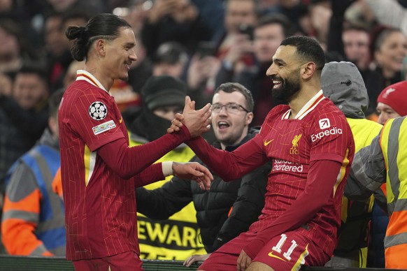 Liverpool&#039;s Mohamed Salah, celebrates with his teammate Darwin Nunez after scoring his side&#039;s first goal during the Champions League, opening phase soccer match between Liverpool and Lille a ...