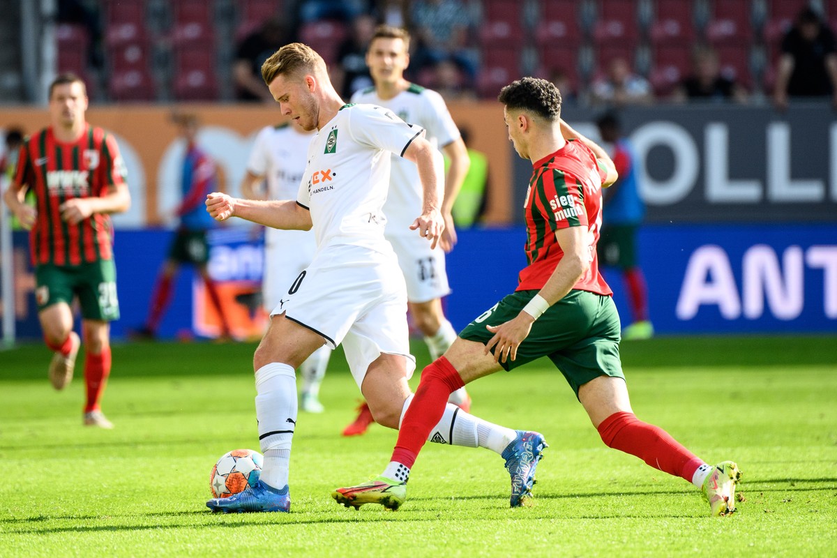 18.09.2021, Bayern, Augsburg: Fu�ball: Bundesliga, FC Augsburg - Borussia M�nchengladbach, 5. Spieltag in der WWK-Arena. Nico Elvedi von M�nchengladbach (l) und Ruben Vargas von Augsburg im Zweikampf  ...