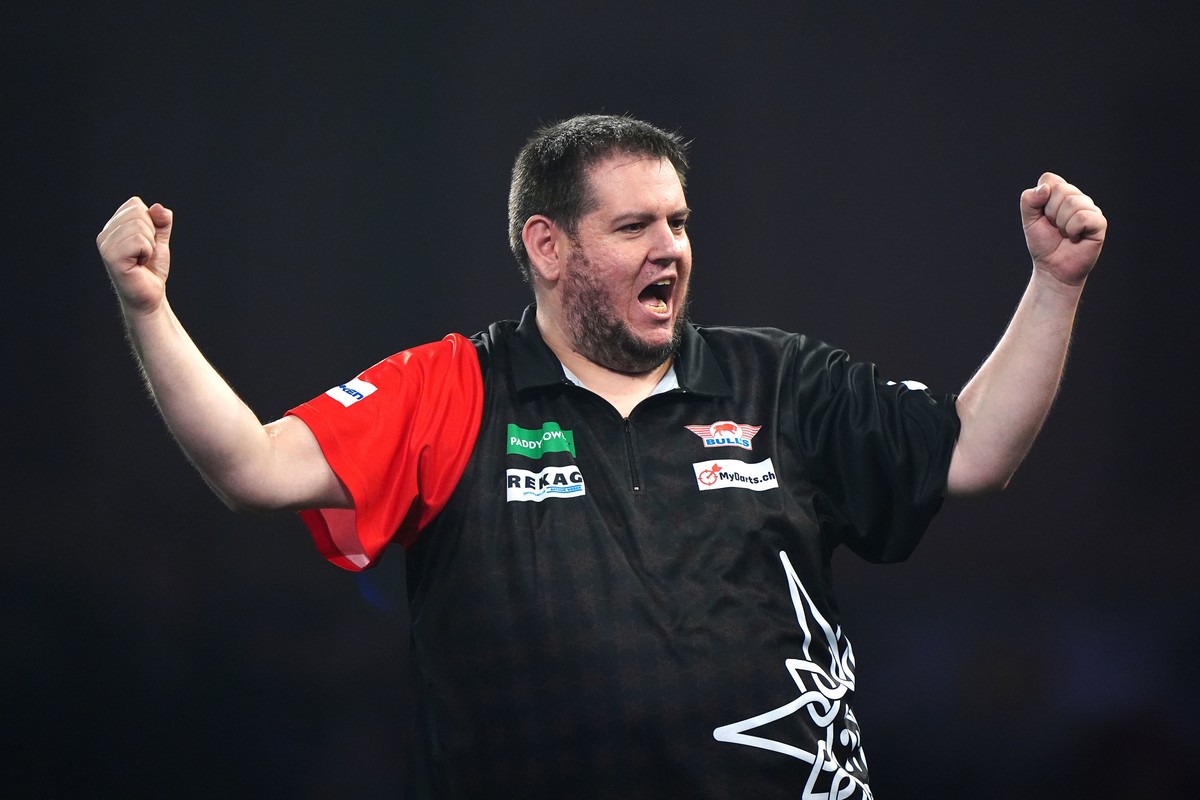 Switzerland's Stefan Bellmont celebrates winning the first set against Australia's Damon Heta, not pictured, during the Round 2 match on day eleven of the World Darts Championship at the Ale ...