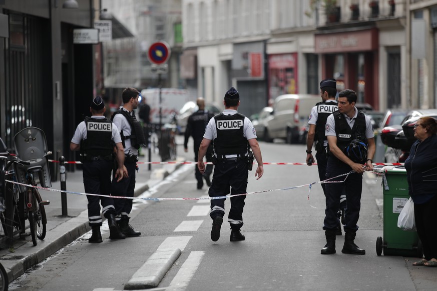 Police cordon off the area, near the scene of a hostage situation, in central Paris, France, Tuesday, June 12, 2018. Police in riot gear on Tuesday surrounded the entrance of a building in central Par ...